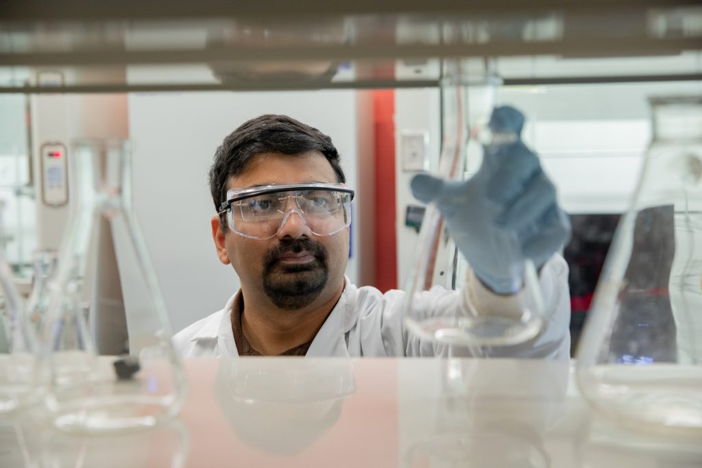 Amit working on research in a lab.