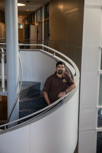 Amit posing on a spiral staircase in engineering hall.
