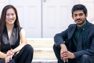 Naman and Terry are sitting on the stairs of Bunce Hall.