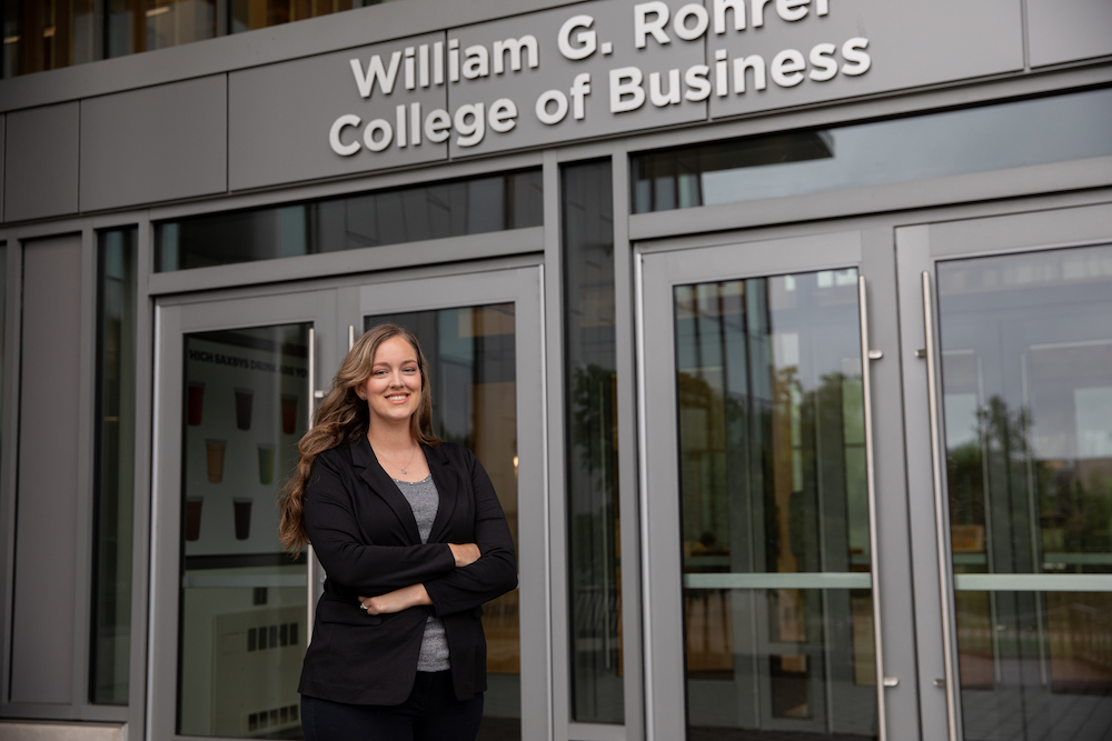 MBA/MSF accelerated student Kristin Carlson stands in front of Business Hall at Rowan University. 