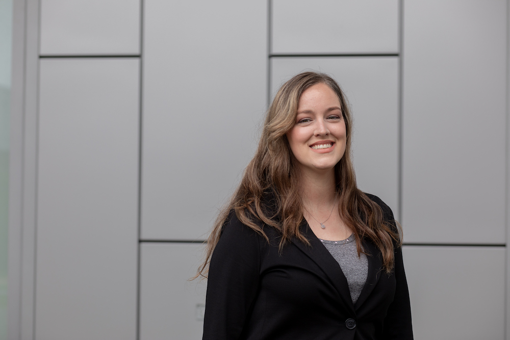MBA/MSF accelerated student Kristin Carlson stands on the side of Business Hall at Rowan University.