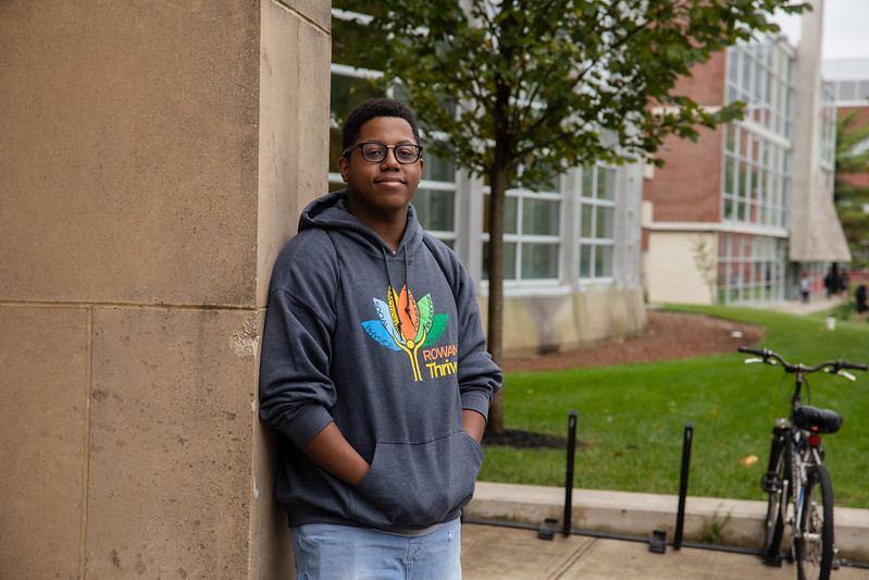 Rowan Health and Science Communication major Sedrick stands in front of the Campbell Library.