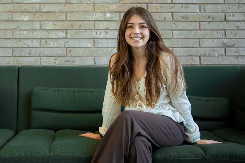 Rowan University Supply Chain and Logistics major Alivia sits on a couch in Discovery Hall.