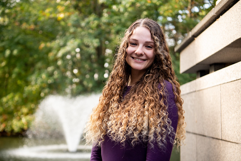 Biomedical Engineering graduate Lauren Repmann smiles in front of Engineering Pond.