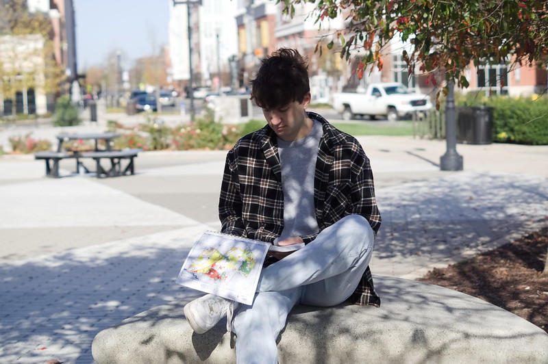 Jon sits, reading through a zoning map.