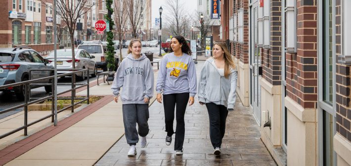 Biomedical Engineering major Miral walks down Rowan Boulevard with two friends.