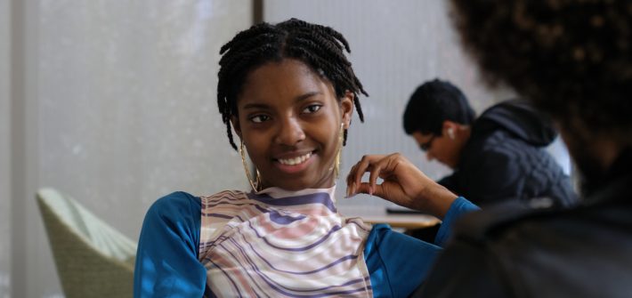 Jeszenee Turner sits smiling in Discovery Hall.