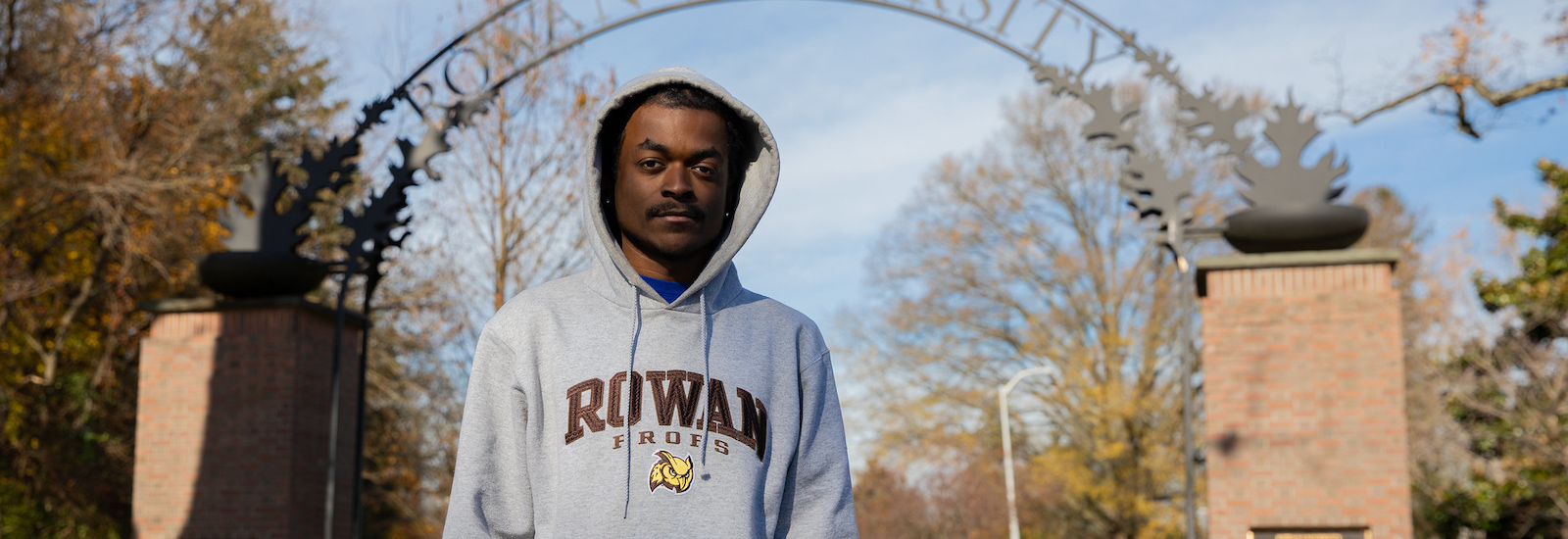 Rowan University Law and Justice major Keshawn Porter stands in front of the Rowan arch.