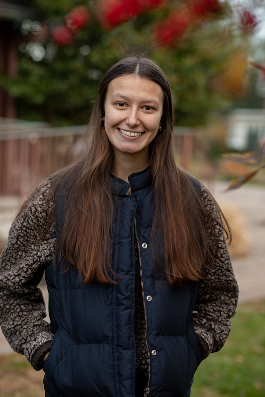 Rowan University Law and Justice major Kayla stands outside on campus near Hollybush Mansion. 