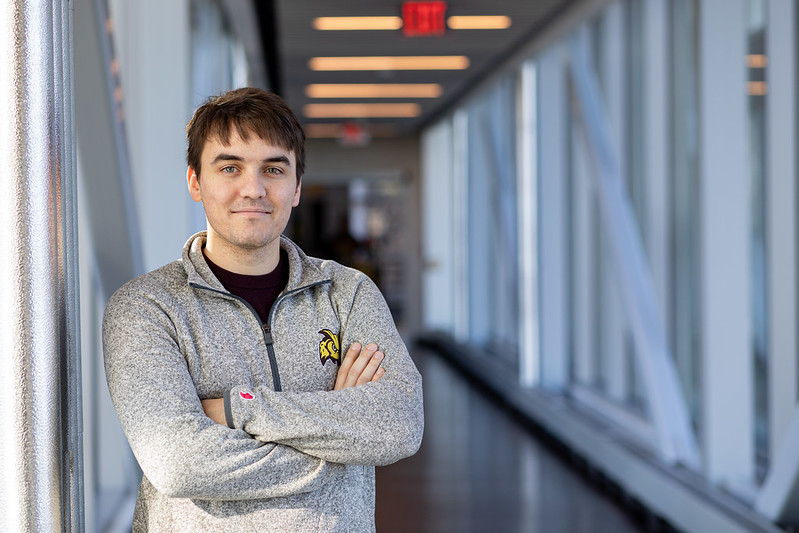 Electrical and Computer Engineering major Benjamin Busler stands inside the Engineering Bridge.