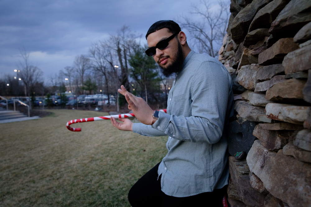 Biological Sciences major Fadi Khan stands by the Time Sweeps art installation at Discovery Hall.