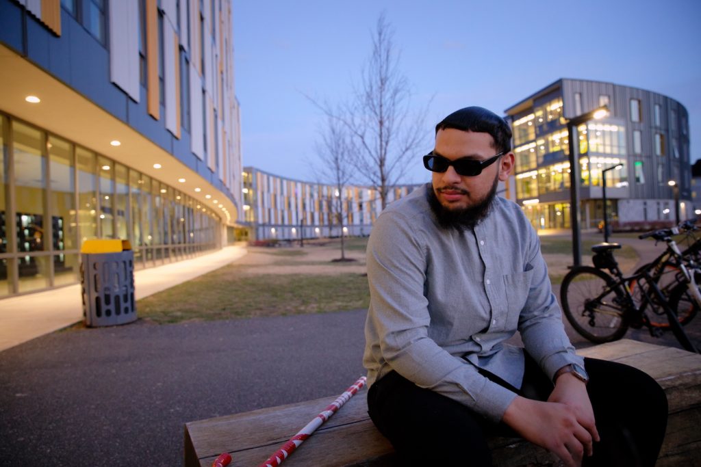 Biological Sciences major Fadi Khan sits outside Holly Pointe Commons.
