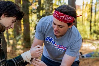 Rowan Health and Physical Education major Gabriel Sherry treats another student in a scenario in Rowan's Wilderness First Responder course.
