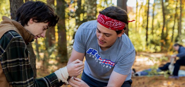 Rowan Health and Physical Education major Gabriel Sherry treats another student in a scenario in Rowan's Wilderness First Responder course.