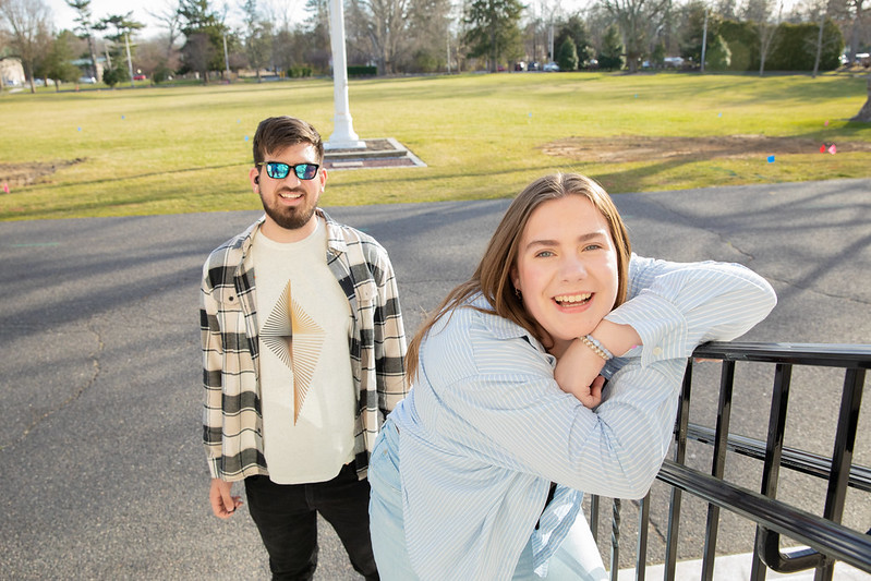 Abigail Cassino casually leans on stair railing while smiling. 