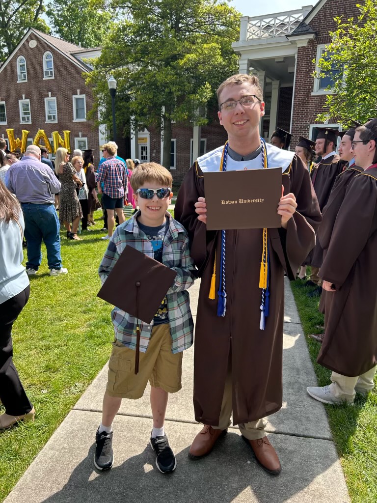 Dylan Snyder (right) pictured on graduation day with his little brother.