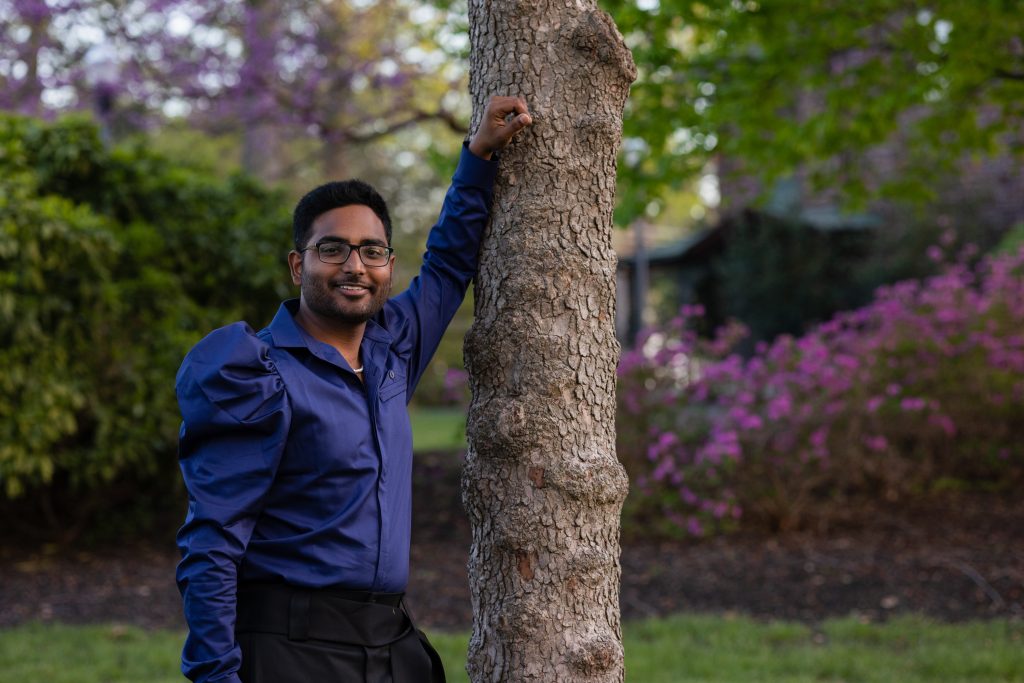 Yash posing in front of a tree