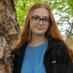 Devon Coulter posing by the trees near Bunce Hall