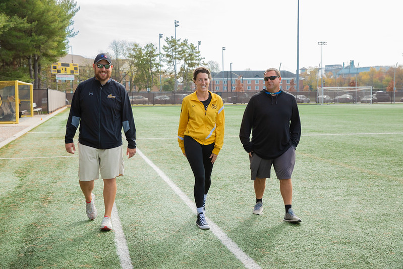 Miranda is walking with her coaches around the soccer field. 