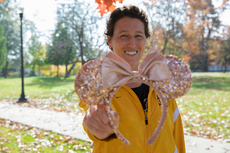 Miranda is holding up a set of Mickey Mouse ears.