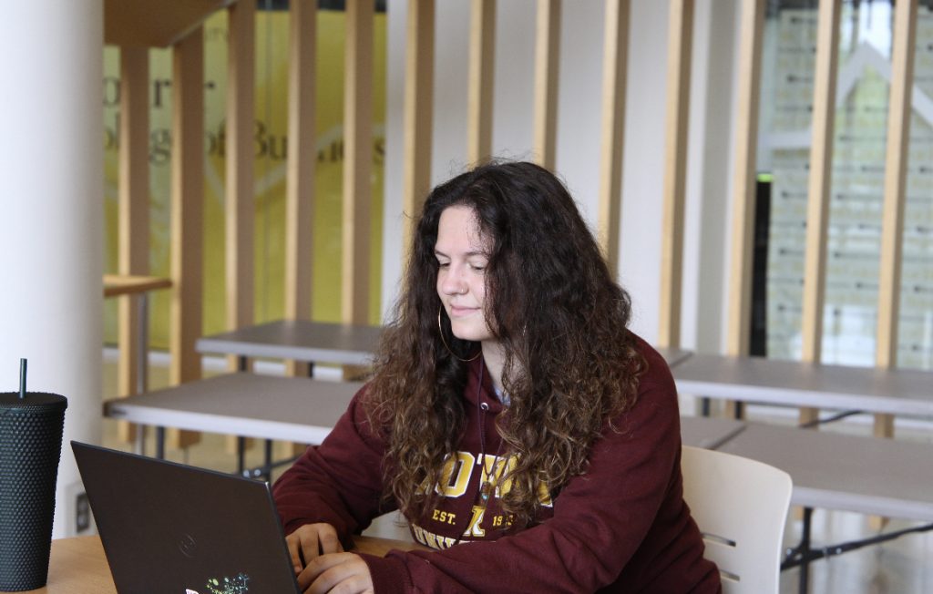 Sophia Lombardo sitting with her computer. 