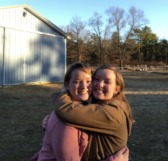 Hannah Goolden and a friend hugging each other.