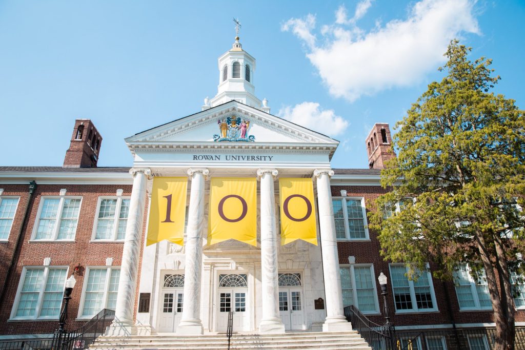 Bunce Hall at Rowan University with the 100 banner in between each column to celebrate the university's centennial. 