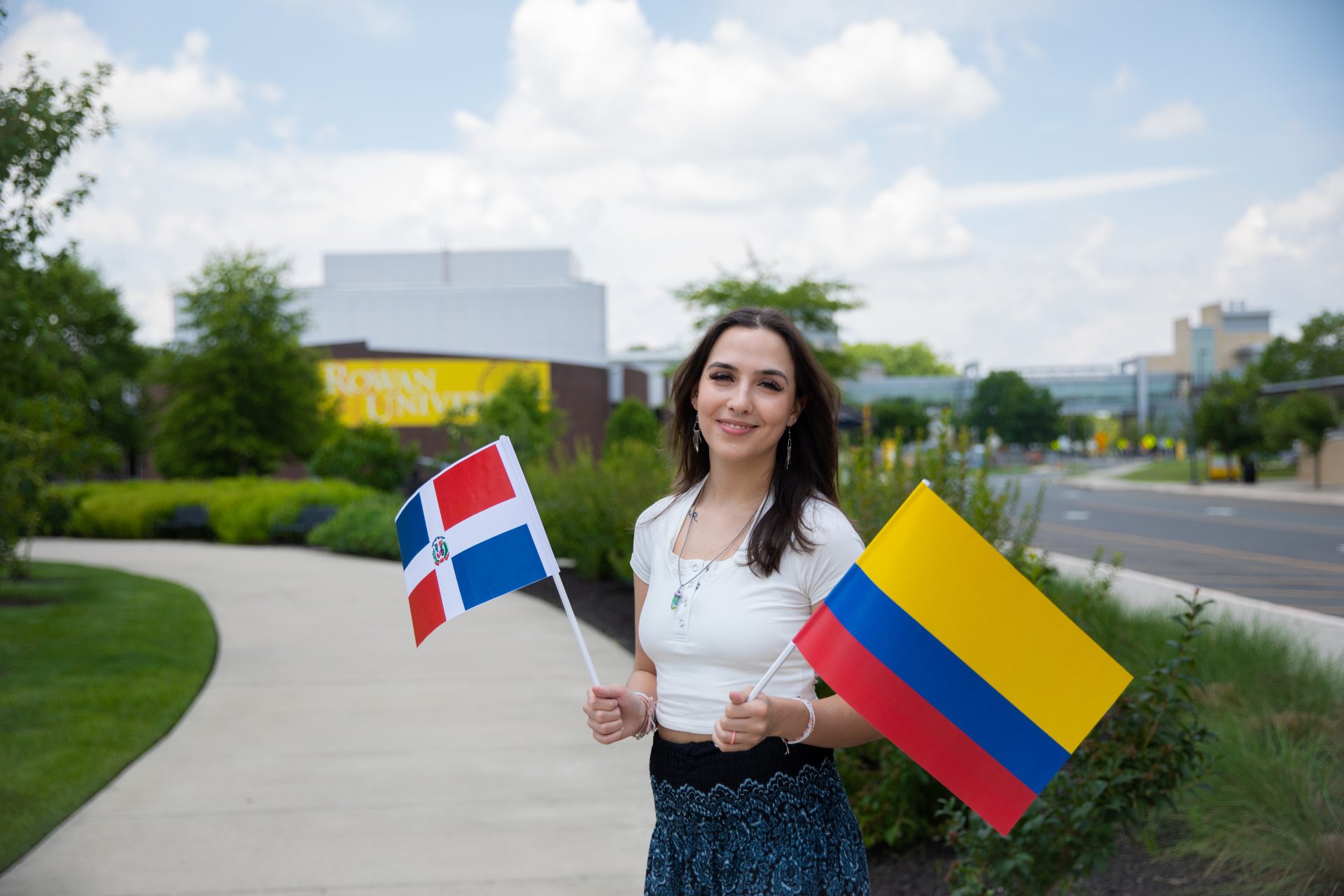 Bonnie holding two flags in her hands (Dominican Republic and Colombia).