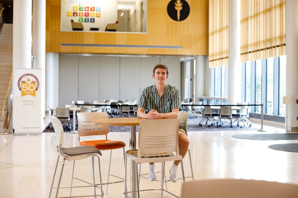 Landon sitting in Business Hall's lobby.