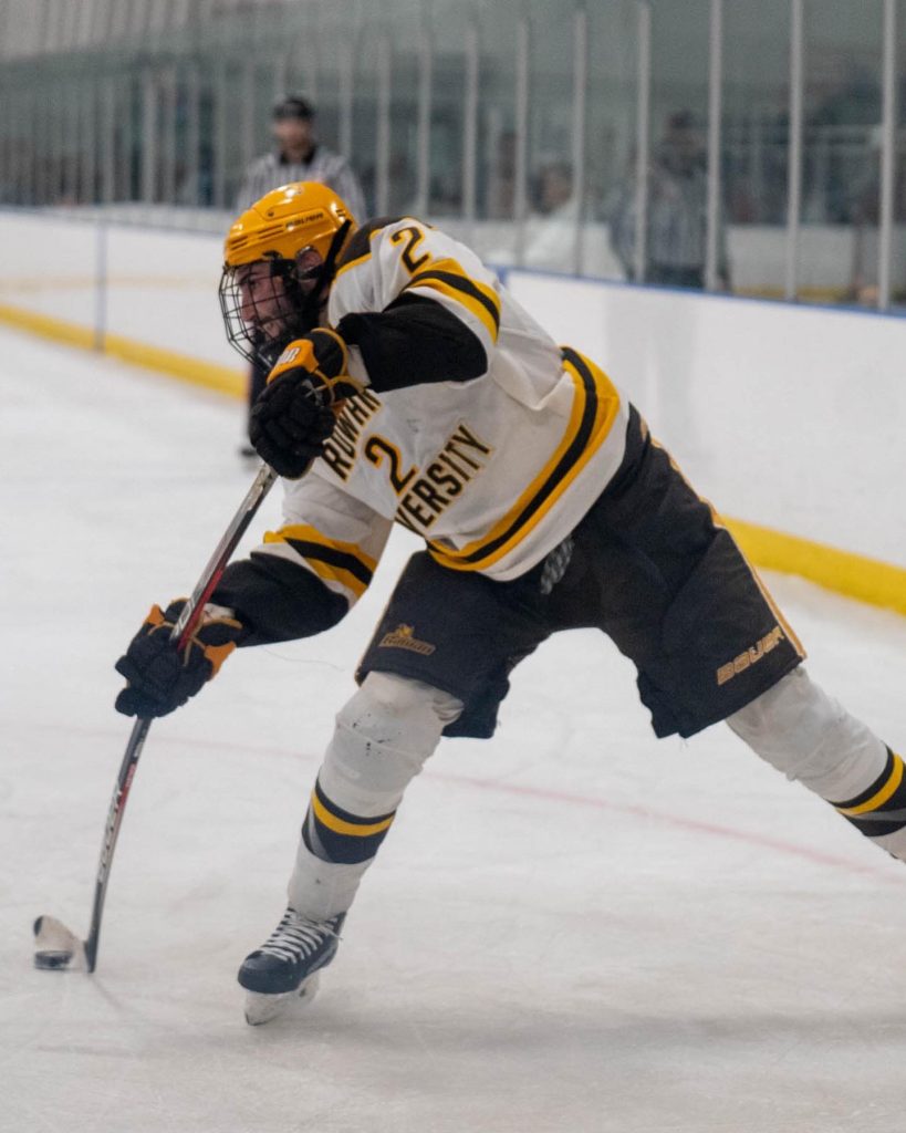 Jared making a cross ice pass in the offensive zone to his teammate.