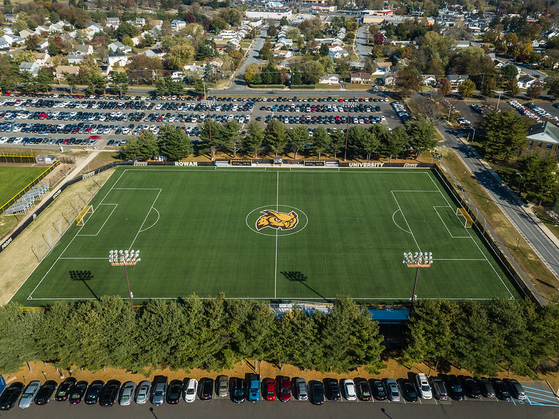 A drone view of the Rowan athletic field, with the mascot of the Prof in the middle on the grass. 