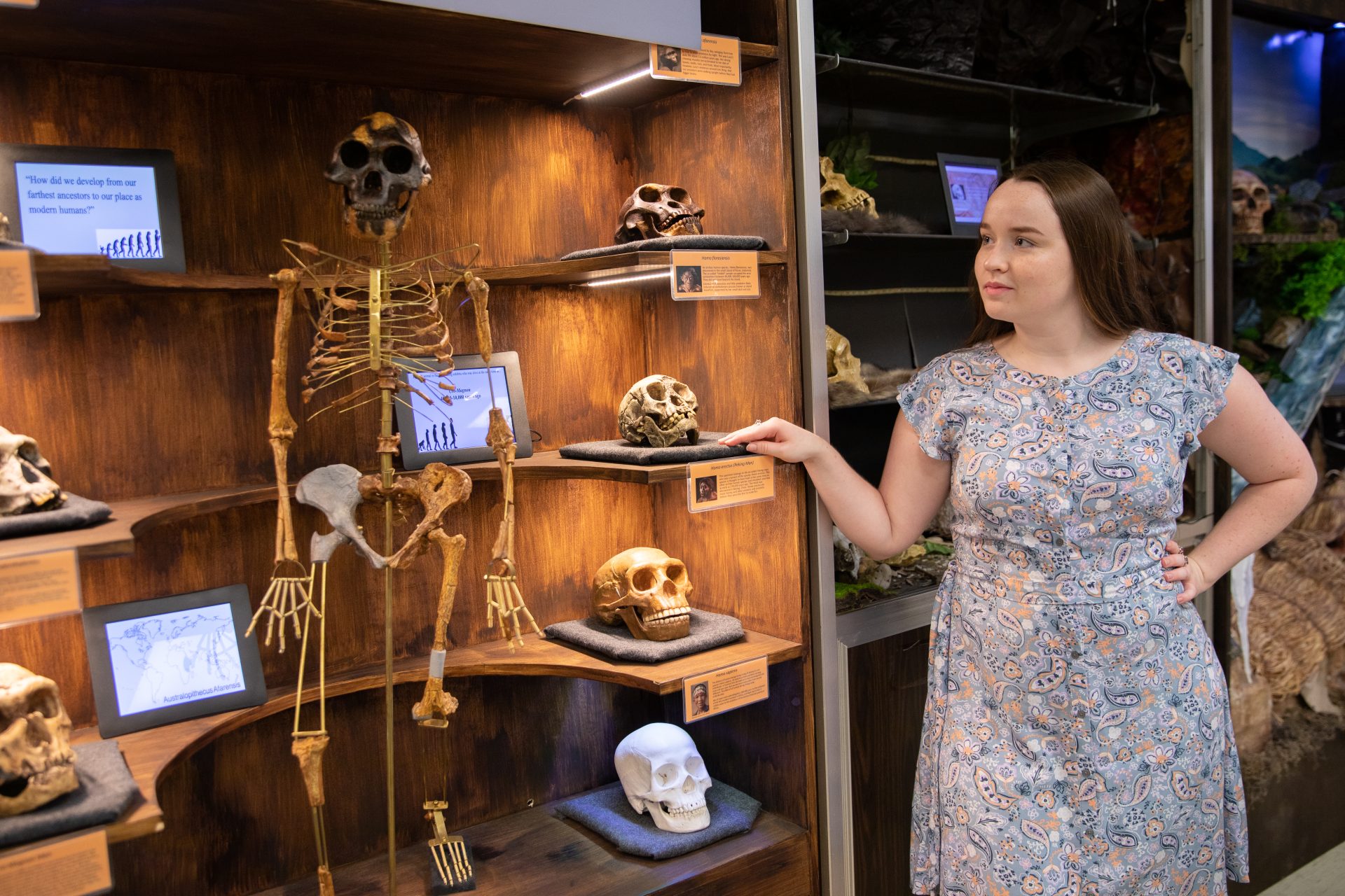 Nicole stands next to a display at the Museum of Anthropology at Rowan University. 