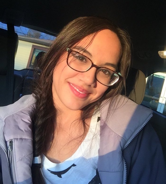 Madison smiles in a selfie from her car.