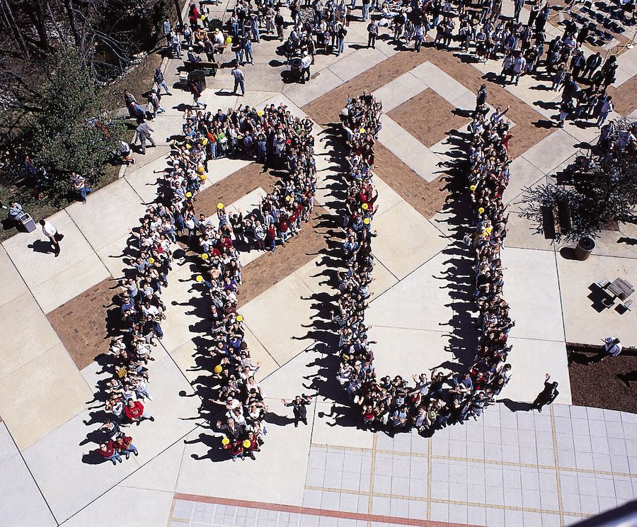Students in spring 1997 create a human sign to spell the initials RU when Rowan became a university. 