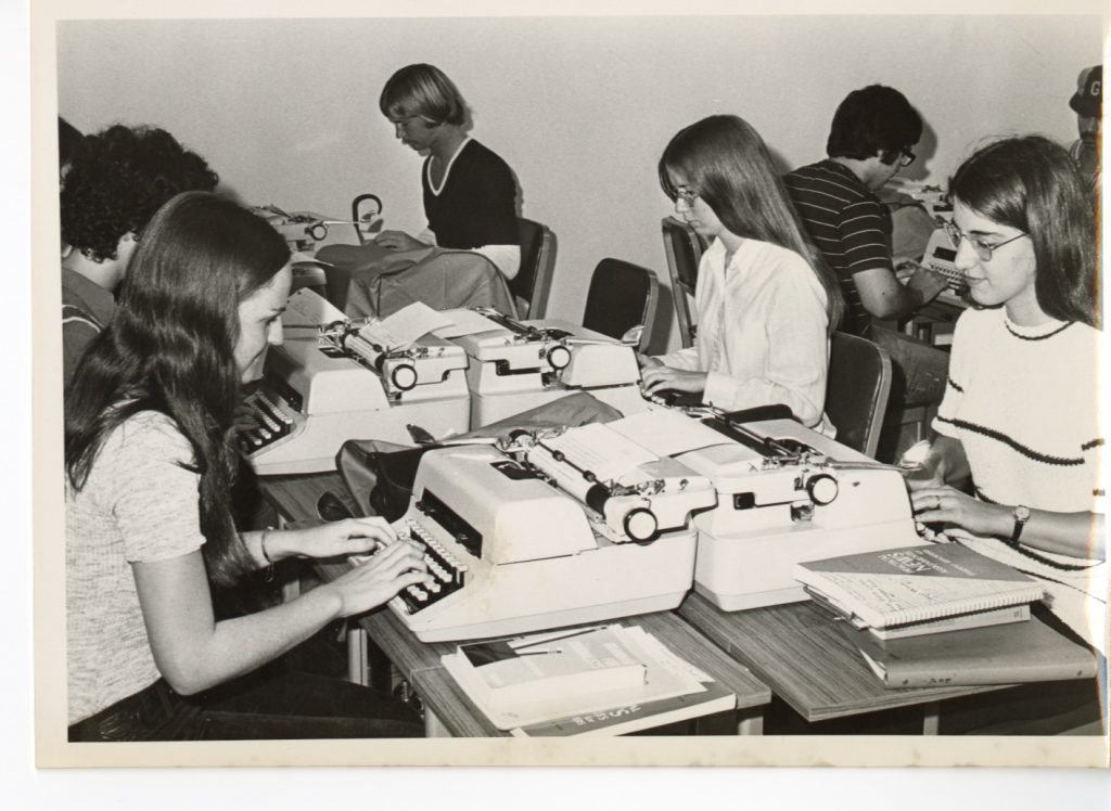 A classroom of students using typewriter, perhaps the 1960s. 