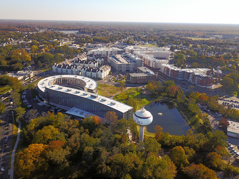 A drone view of the P shape of Holly Pointe Commons, surrounded by campus buildings and trees. 
