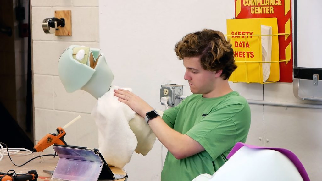 A student working on constructing a puppet in Puppetry Class, held in Westby Hall. 